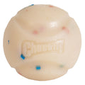The Chuckit! Birthday Fetch Ball Medium by Chuckit! is a durable white natural rubber dog ball with textured grooves, small colored specks, and the raised Chuckit! logo on its surface.