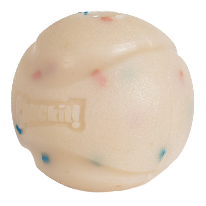 The Chuckit! Birthday Fetch Ball Medium by Chuckit! is a durable, textured off-white natural rubber dog ball with colorful specks and "Chuckit!" embossed, designed as a fun fetch toy for pets.