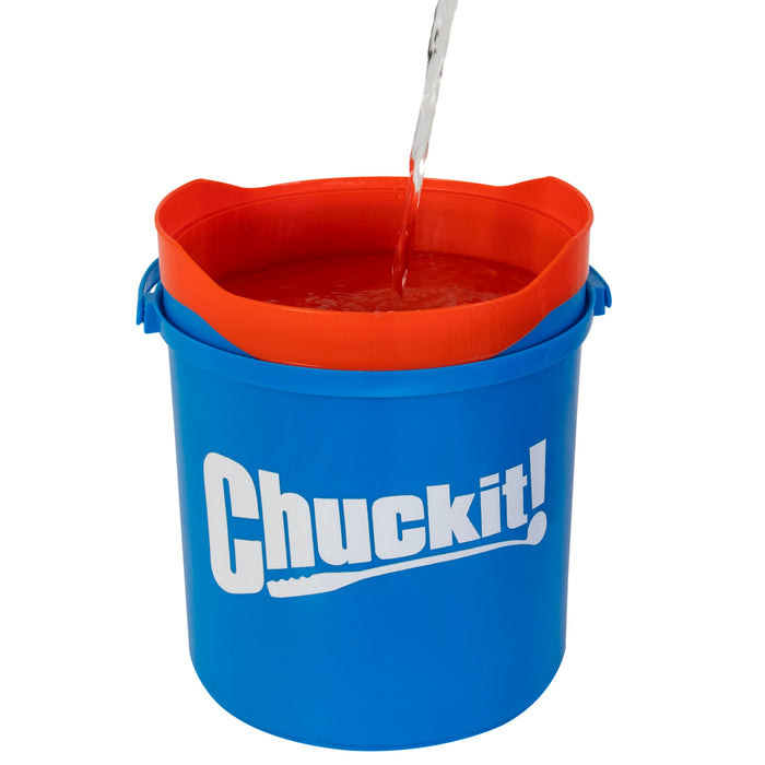 Water streams into a Chuckit! Bucket With Ultra Balls—a blue bucket with an orange rim and "Chuckit!" logo—ideal for rinsing fetch toys or cooling off after playtime from the trusted Chuckit! brand.
