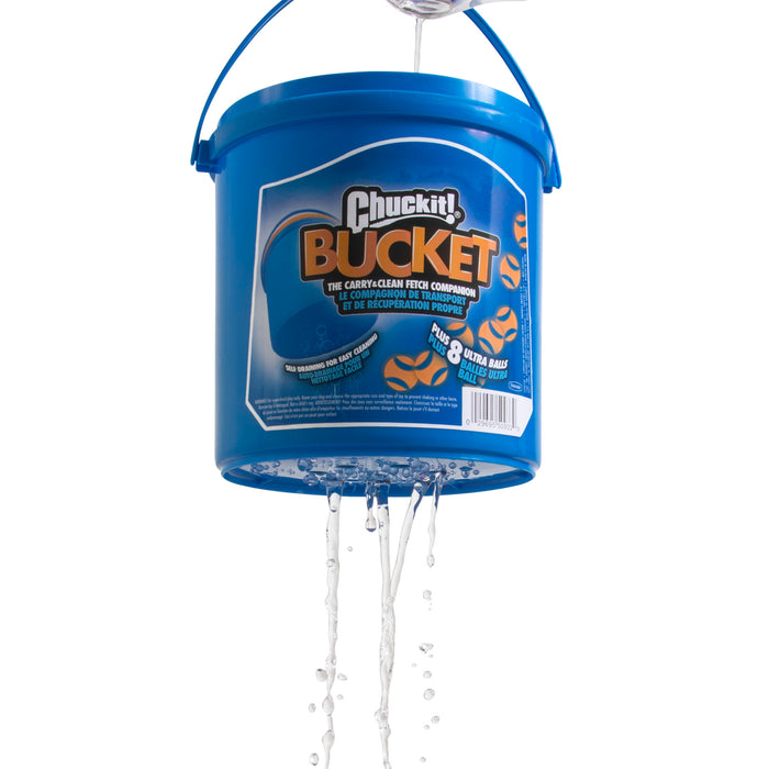 The Chuckit! Bucket With Ultra Balls by Chuckit! is shown in blue, hanging by its handle with water draining from the bottom—ideal for rinsing your fetch toys or Chuckit Ultra Balls after playtime.