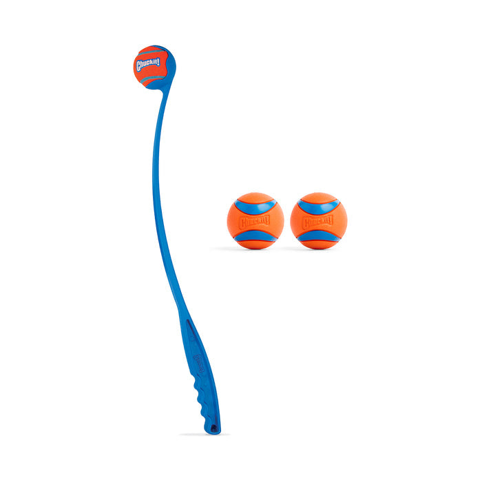A Chuckit! Classic 26M Launcher with handle is placed beside two orange and blue Ultra Balls from the Chuckit! Ultra Ball Medium 3 Pack, all shown on a white background.