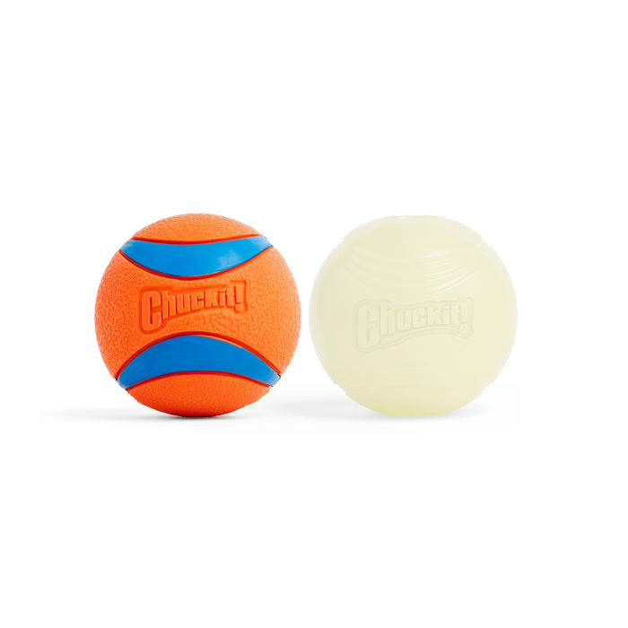 The Chuckit! Day & Night Ultra Ball Large 2 Pack includes an orange and blue Ultra Ball and a glow in the dark fetch toy, both with a textured surface and the Chuckit! logo.