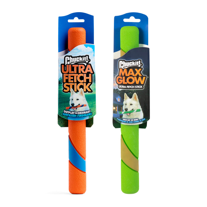 Two Chuckit! Day & Night Ultra Fetch Stick 2 Pack toys in packaging: the orange and blue Ultra Fetch Stick on the left and the glow-in-the-dark Max Glow Ultra Fetch Stick on the right, both featuring a playful white dog.