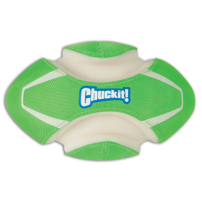 The Chuckit! Fumble Fetch Max Glow is a green and white dog football toy shaped like a football, with white curved ridges and "Chuckit!" in blue and white text. It glows in the dark for fun nighttime fetch sessions.