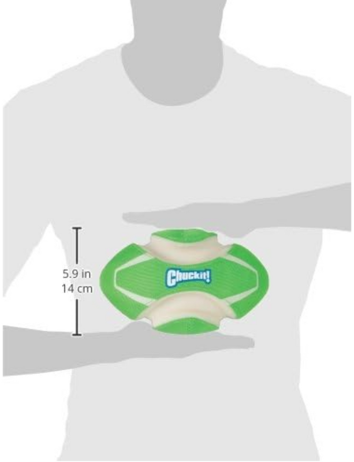 A person holds a Chuckit! Fumble Fetch Max Glow dog toy, green and white, football-shaped, 5.9 inches (14 cm) tall. This glow-in-the-dark fetch toy is from Chuckit!.