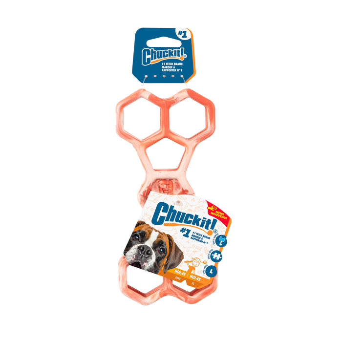 The Chuckit! Hol-ee Bone is an orange dog toy with hexagonal holes, shown in packaging featuring a dog photo and a blue and white label with product information. Brand: Chuckit!.