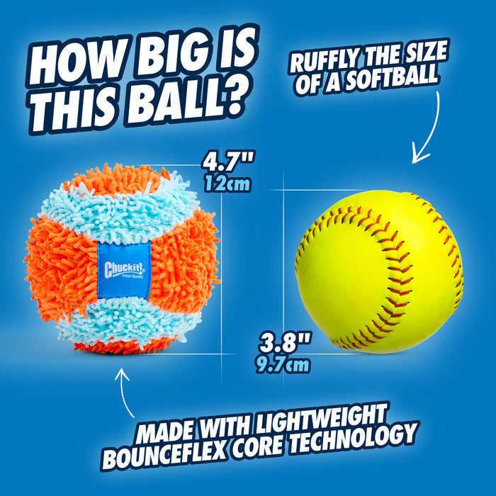 A fluffy orange and blue Chuckit! Indoor Ball (4.7"/12cm) by Chuckit! is shown beside a yellow softball (3.8"/9.7cm) for size comparison, with text highlighting its lightweight Bounceflex Core technology.