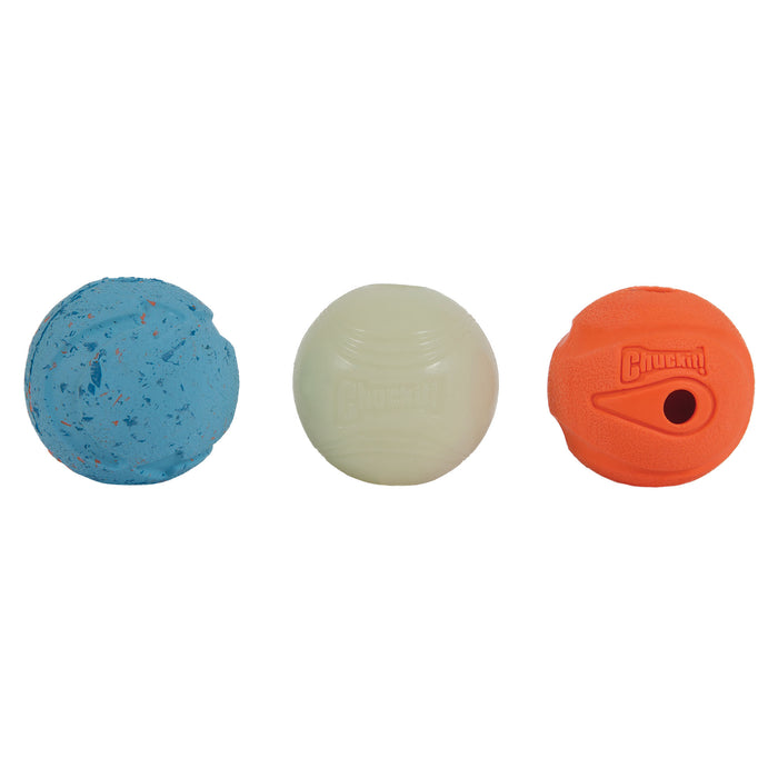Three dog balls from the Chuckit! Medium Fetch Medley Dog Ball Set by Chuckit! are shown: a blue speckled ball, a glow-in-the-dark ball, and an orange “Chuckit!” branded ball with a hole, all displayed against a white background.