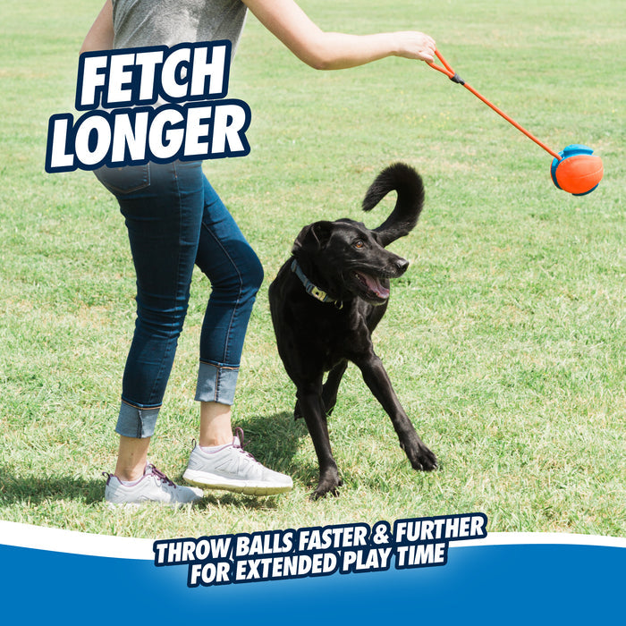 Wearing jeans and sneakers, someone plays fetch with a happy black dog using the Chuckit! Rope Fetch Dog Toy by Chuckit! on a grassy field. Text: Fetch Longer. Throw faster & further for more play with this fun toy.