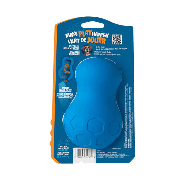 The Chuckit! Tumble Teez Dog Treat Puzzle Toy by Chuckit! is a blue, peanut-shaped rubber toy with hexagon patterns, designed to challenge dogs mentally. It comes in blue and orange bilingual retail packaging with a dog photo above the product info.