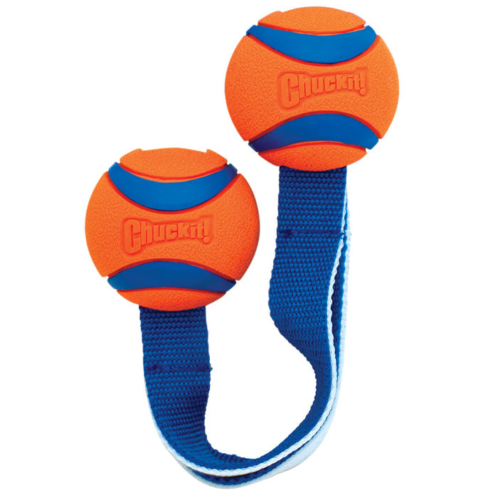The Chuckit! Ultra Duo Tug Dog Toy Med by Chuckit! features two orange and blue rubber balls linked by a nylon strap, making a durable tug toy for interactive throwing, fetching, and tugging with your dog.