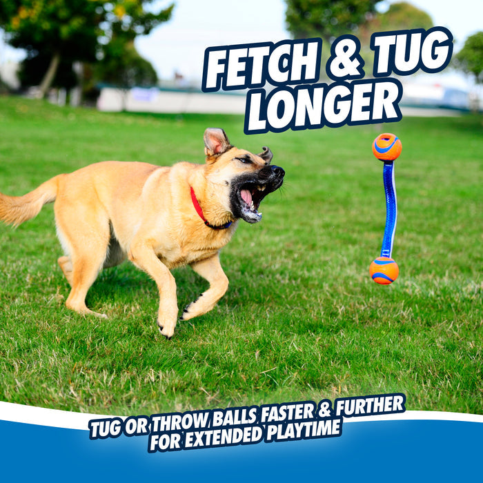 A tan dog excitedly chases the Chuckit! Ultra Duo Tug Dog Toy Med in blue and orange across a grassy field. Bold text reads, Fetch & Tug Longer, with smaller text promoting extended playtime by throwing or tugging Chuckit!'s toy.