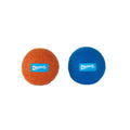 Two fuzzy Chuckit! Wool-ee Balls, made from natural wool, are displayed side by side on a white background—one orange, one blue. Each features the blue Chuckit! logo label and offers an eco-friendly dog toy option.