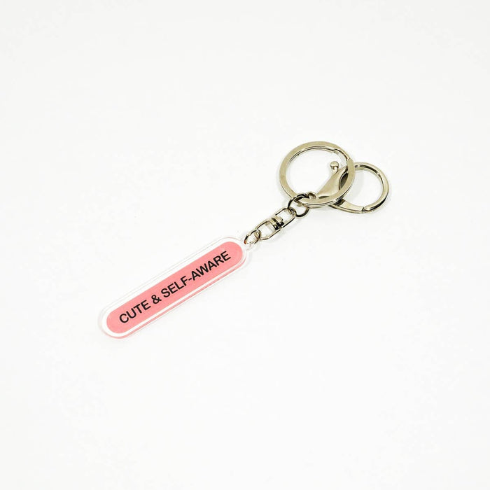 Keychain with 'Cute & Self Aware' tag on a white background