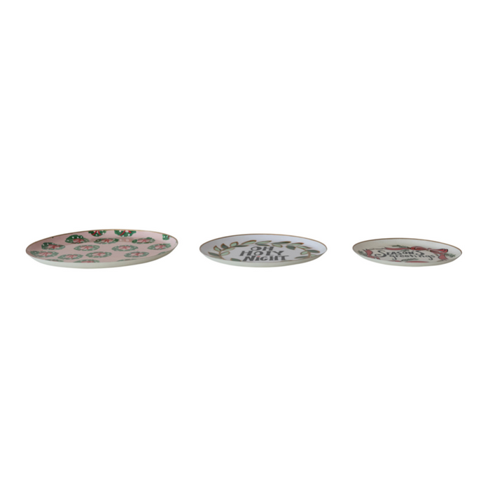 Three oval ceramic plates with pink floral designs and decorative text, arranged horizontally on a plain white background.