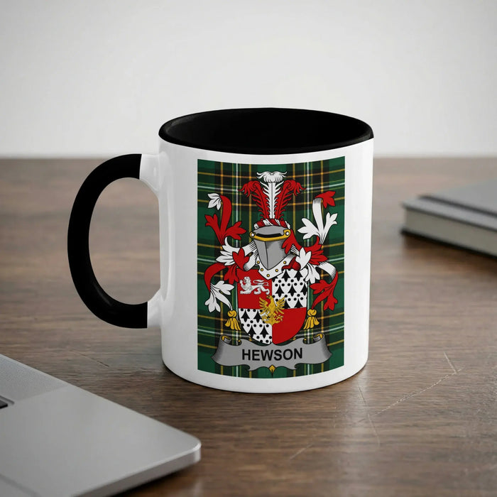 White mug with black handle featuring the Hewson family crest.