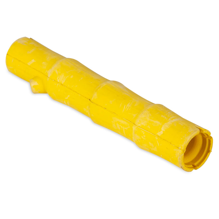 The JW Bamboo Stick by JW Pet is a yellow, bamboo-shaped rubber dog toy with a textured surface and visible seams, designed for treat stuffing and photographed on a white background.