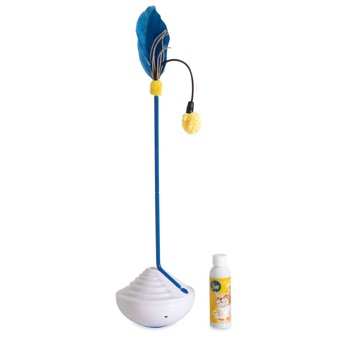 A white dome-shaped interactive cat toy has a tall blue rod with a blue feather and yellow fluffy ball. Next to it is the JW Catnip Mister by JW Pet, providing automatic catnip delivery for endless feline fun.