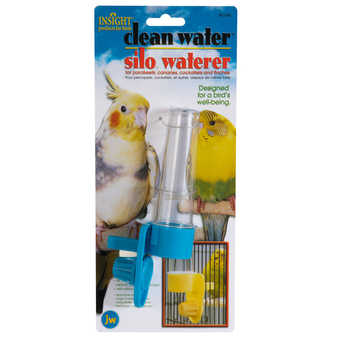 The JW Pet Clean Water Silo Bird Waterer features a transparent silo, blue base, and yellow clip. Ideal cage accessory for parrots, canaries, cockatiels, and finches. Packaged with bird images.