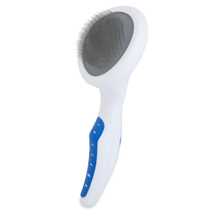 The JW Pet JW Gripsoft Slicker Brush With Soft Pins features an oval head with fine metal bristles and a curved handle, ideal for gently grooming pets with sensitive skin and removing loose fur.