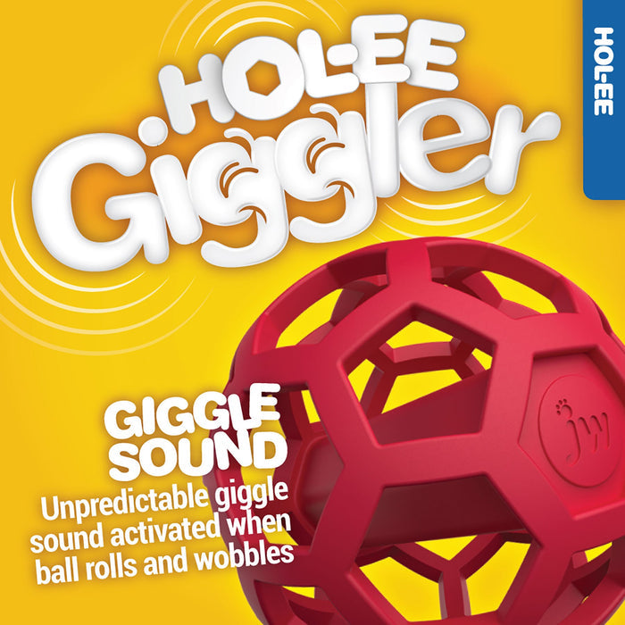 The JW Hol-ee Giggler Dog Toy by JW Pet, a red geometric rubber ball, is displayed on a yellow background. This interactive toy makes unpredictable giggle sounds as it rolls and wobbles, keeping dogs entertained.