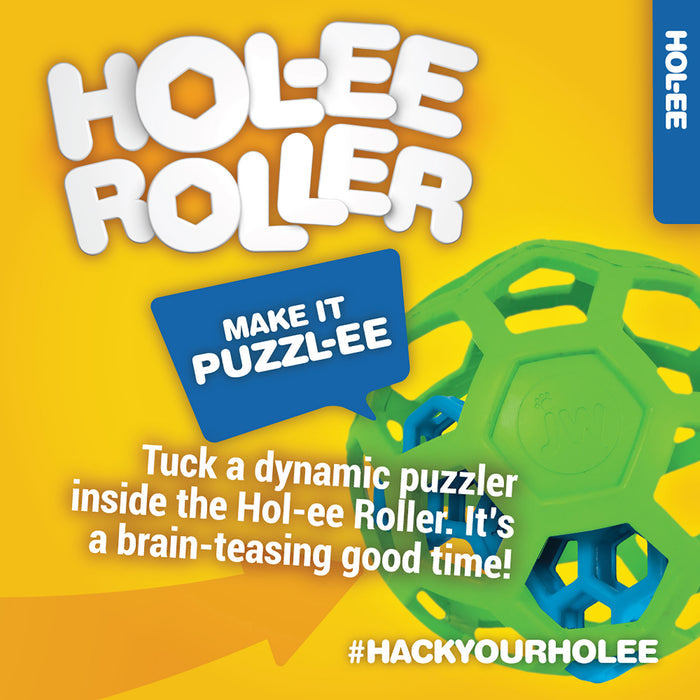 A JW Pet JW Hol-ee Roller Dog Toy in teal, with a blue puzzle inside, is displayed on yellow. Text reads: Make it puzzl-ee. Tuck a dynamic puzzler in the Hol-ee Roller for brain-teasing fun! #HackYourHolee.