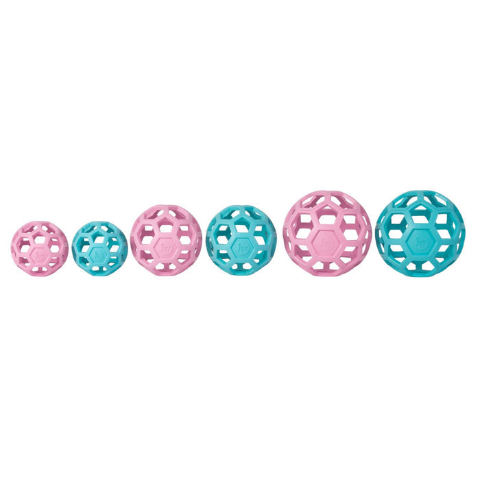 Six JW Pet JW Hol-EE Roller Trend-EE balls, hollow and geometric, alternate pink and teal as they increase in size from left to right—ideal for dog mental stimulation. Displayed in a row on a white background.