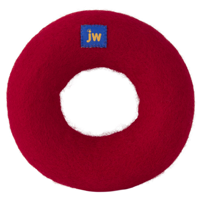 The JW Wool-ee Ring Dog Toy by JW Pet is a round, red felt ring with a small blue "jw" patch on top. Its hollow center and soft, fuzzy surface make it an eco-friendly and fun toy for your pup.