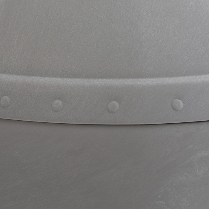 Close-up of the Petmate Husky Dog House by Petmate, showcasing a metallic surface with a lightly brushed texture and a curved seam accented by evenly spaced rivets for an industrial look.