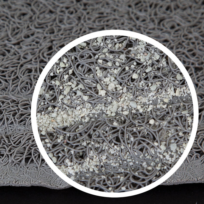 The Petmate Paws Large Litter Catcher Mat by Petmate features a gray surface with magnified circular areas displaying tangled loops that resemble cats paws or fibers, scattered with tiny white particles like litter scatter, highlighting its intricate and functional texture.