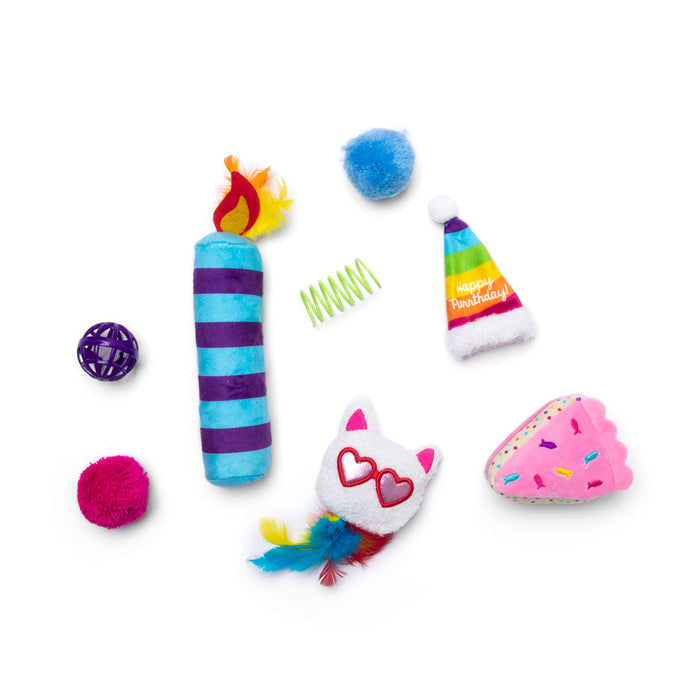 The Quirky Kitty Birthday Box 8pk by Quirky Kitty features colorful cat birthday toys like a striped candle, fuzzy balls, spring, party hat, pink frosted cake slice, and a white cat face with heart glasses and feathers.