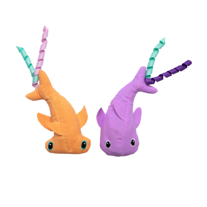 The Quirky Kitty Color Changing Shark 2pk by Quirky Kitty features two ocean-themed catnip toys—one orange with teal eyes and pink/teal ribbon, the other purple with black eyes and green/purple ribbon—perfect for playful cats.
