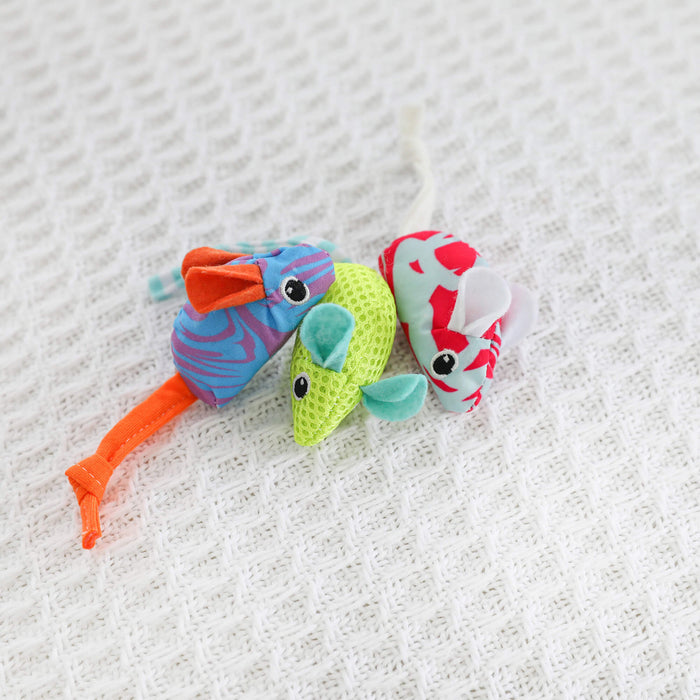 The Quirky Kitty Cool Mice 3 Pack—ocean-themed, catnip-filled toys in blue, green, and white—rests on textured white fabric, delivering interactive cooling fun for cats who love playful toys from Quirky Kitty.