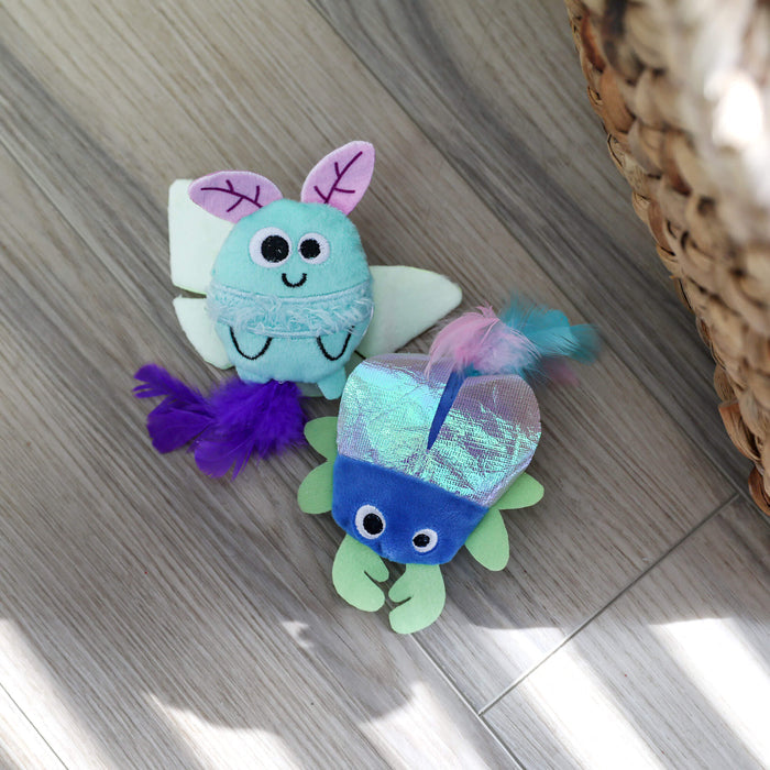 Quirky Kitty Luna Bugs 2pk glow-in-the-dark cat toys feature a light blue bug and blue-green fish, both with catnip and silvervine. These whimsical, forest-inspired toys add fun to your cat's playtime.