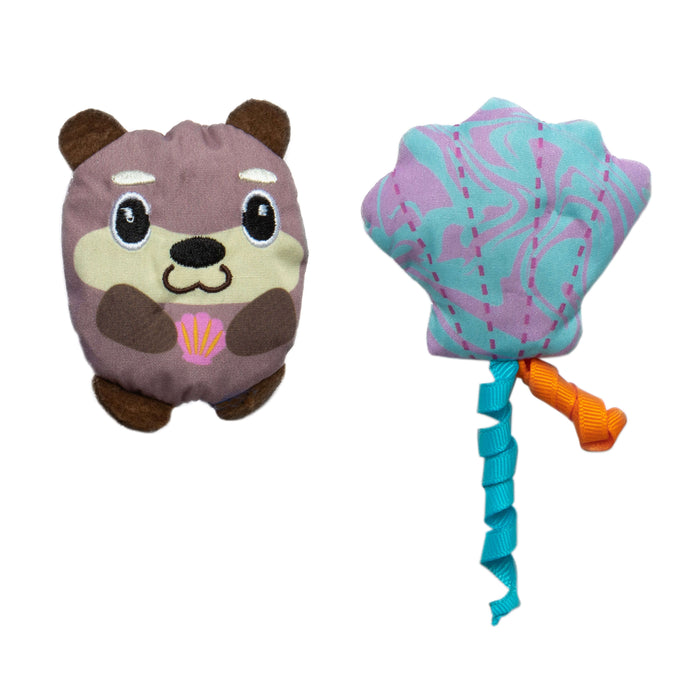 The Quirky Kitty Otterly Cool 2-Pack includes a smiling brown otter toy with a pink seashell and an ocean-themed pastel blue and purple seashell toy with ribbon streamers, both cooling cat toys with catnip.