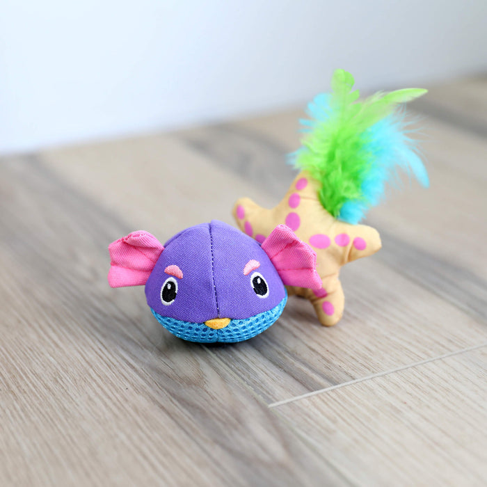 The Quirky Kitty Pufferfish Pals Cat Toys 2-Pack features a purple and blue fish toy with pink fins and a yellow star toy with pink dots, green, and blue feathers, both shown on a wooden floor.