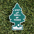 Iron-on embroidered patch with the shape of a pine tree and the words "Stop and smell the pines".